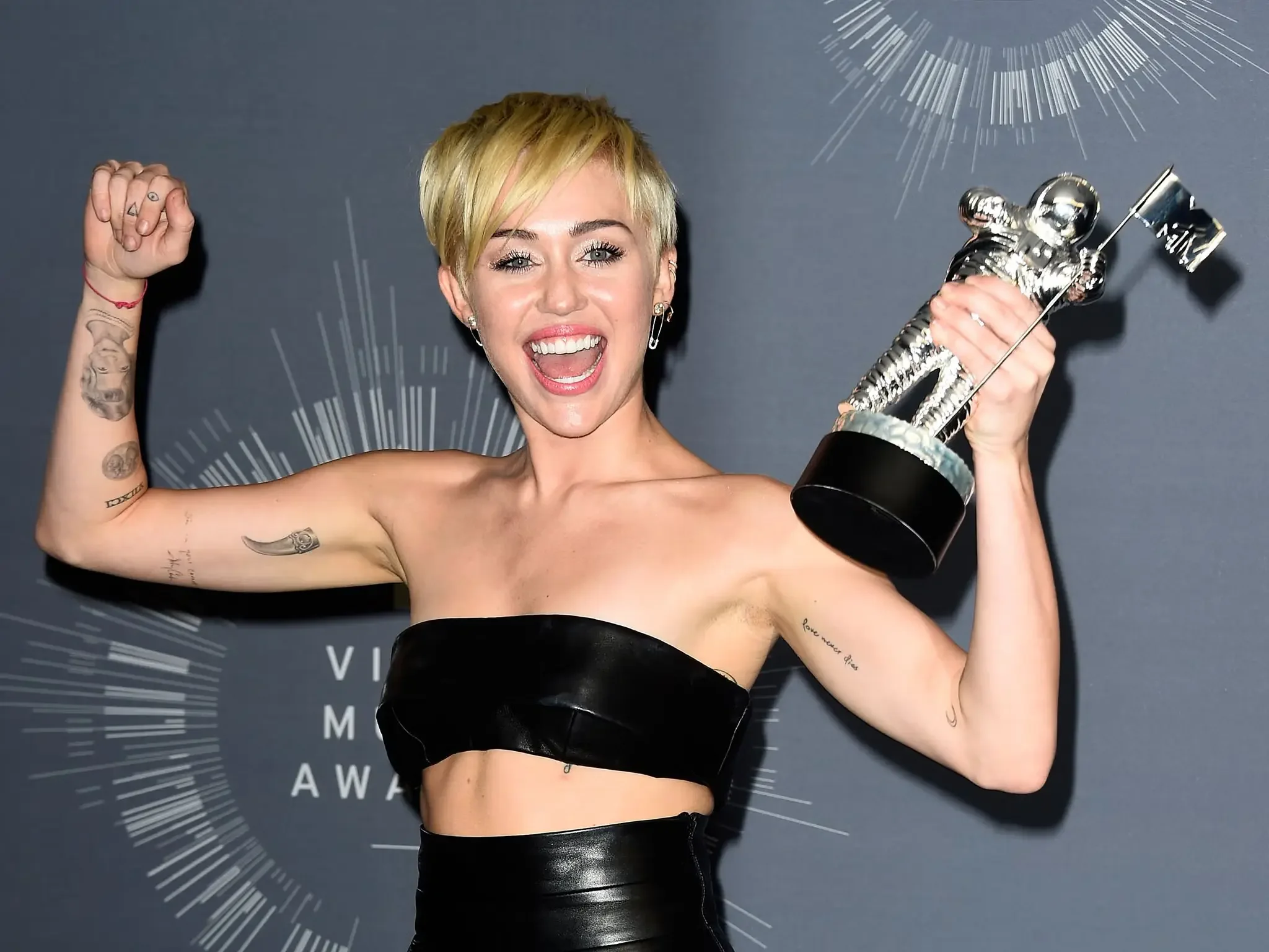 Miley Cyrus enthusiastically receiving a reward